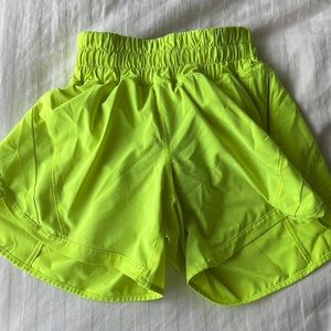 Women’s Neon yellow high rise lululemon track that shorts 4inch size 2